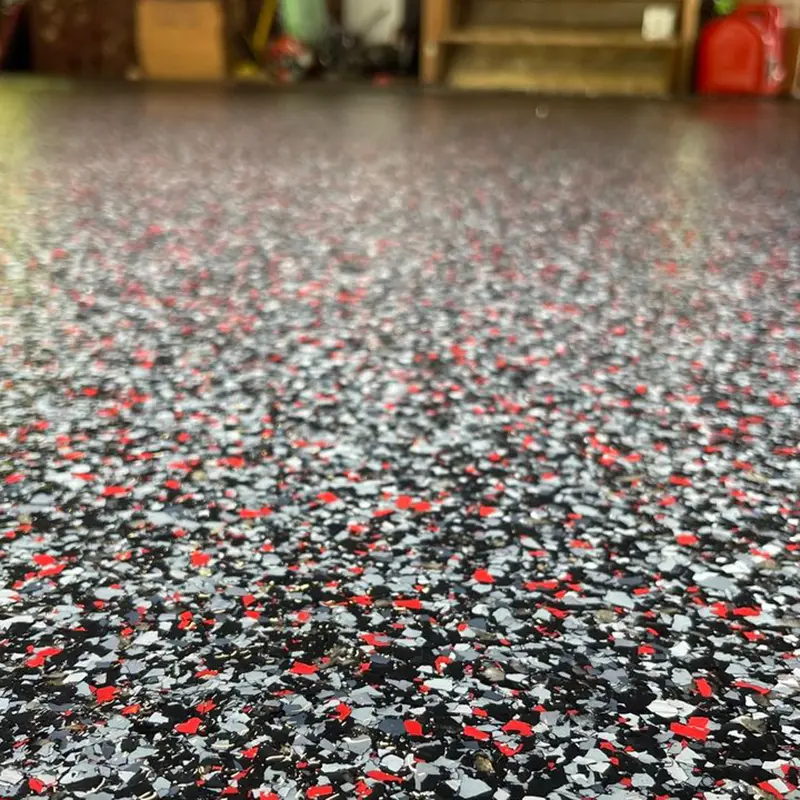Close up of red grey white and black flake floor